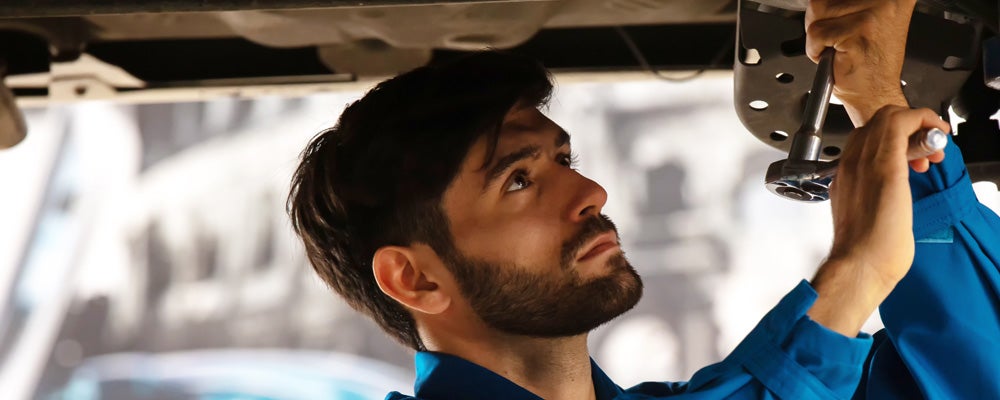 Service center technician doing maintenance work on Genesis vehicle Genesis Of Cartersville in Cartersville GA